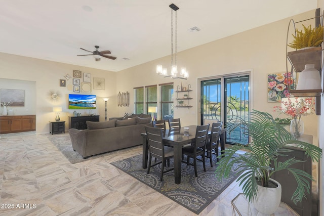 dining room with ceiling fan with notable chandelier