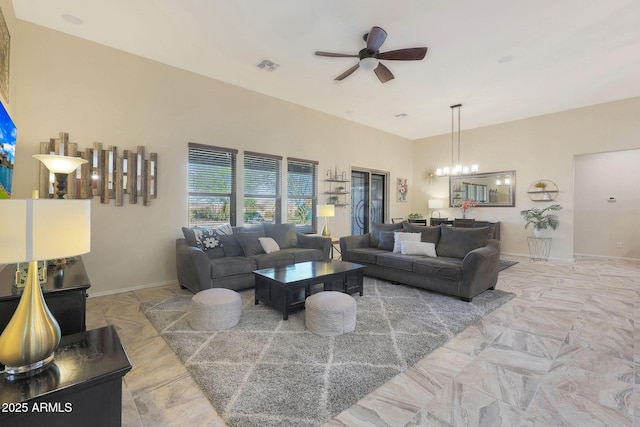 living room with ceiling fan with notable chandelier