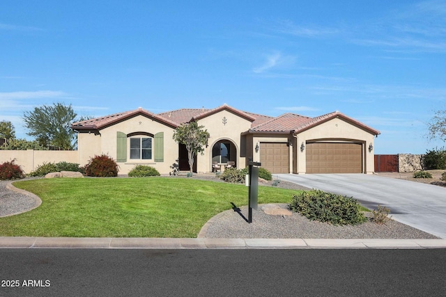 mediterranean / spanish house featuring a garage and a front yard