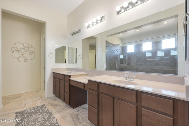 bathroom with a tile shower and vanity