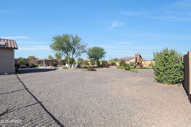 view of yard featuring a gazebo and a playground