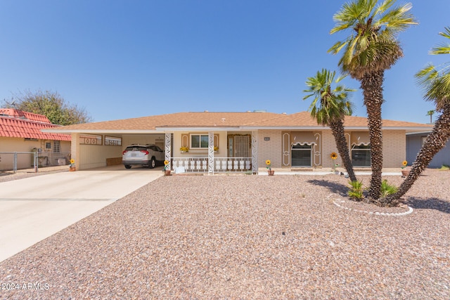 single story home featuring covered porch and a carport