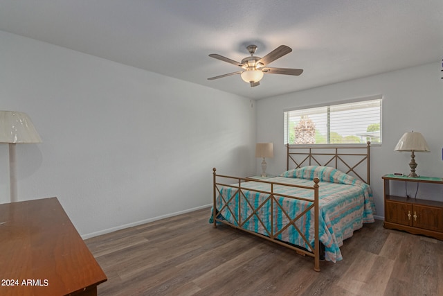 bedroom with ceiling fan and dark hardwood / wood-style floors