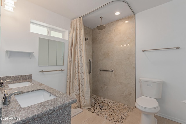 bathroom with vanity, a shower with curtain, toilet, and tile patterned flooring