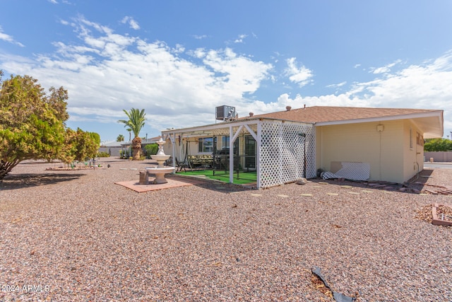 back of property featuring a pergola