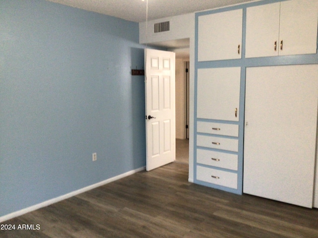 unfurnished bedroom featuring dark hardwood / wood-style floors