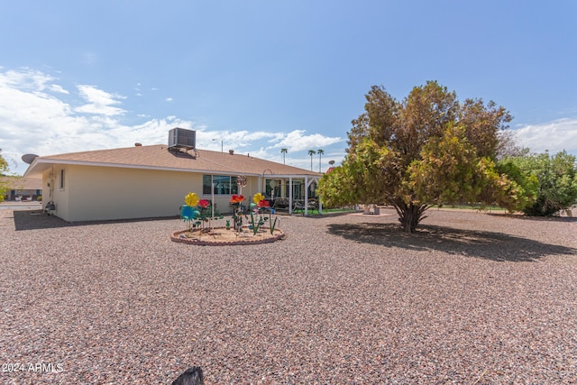 back of house with central air condition unit and a patio area