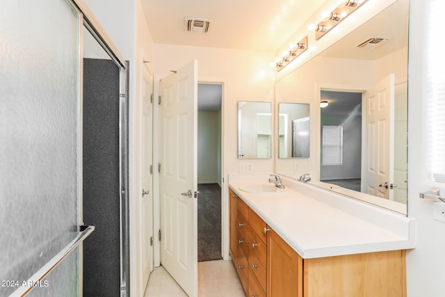 bathroom featuring tile patterned flooring and vanity