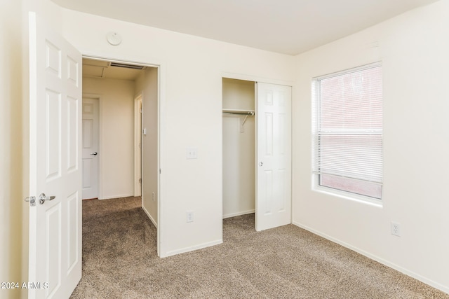 unfurnished bedroom featuring a closet and carpet flooring