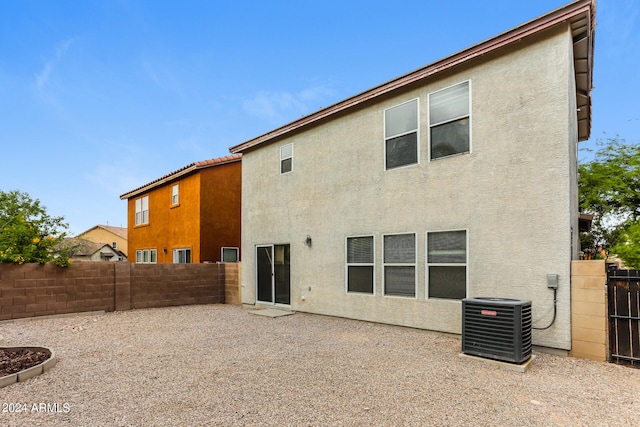 rear view of property with a patio area and cooling unit