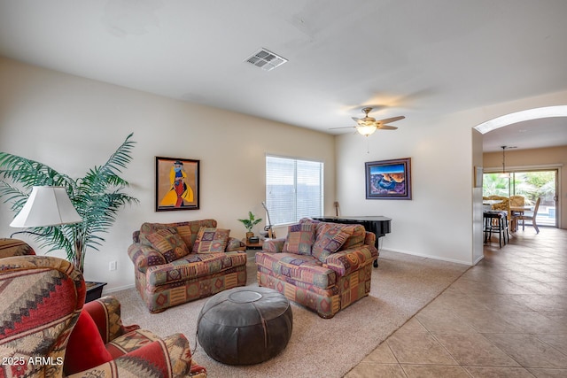 living room with ceiling fan, light tile patterned floors, and a wealth of natural light