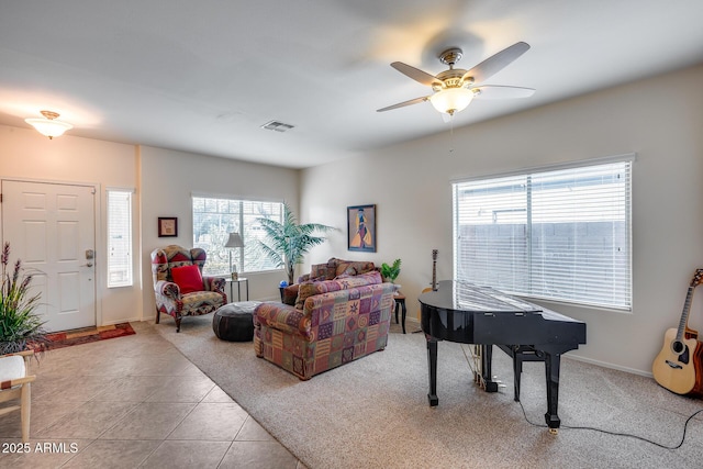 living room featuring ceiling fan and light tile patterned flooring