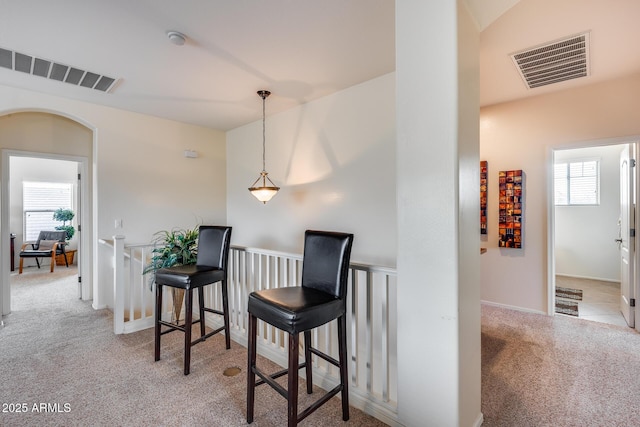 living area featuring light carpet