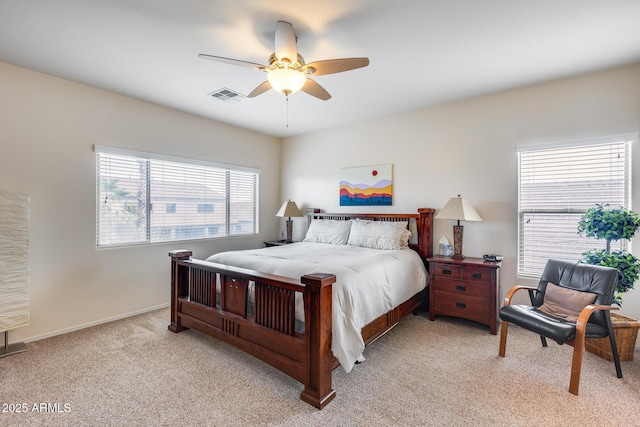 bedroom featuring multiple windows, light carpet, and ceiling fan