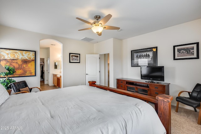 carpeted bedroom featuring ensuite bathroom and ceiling fan