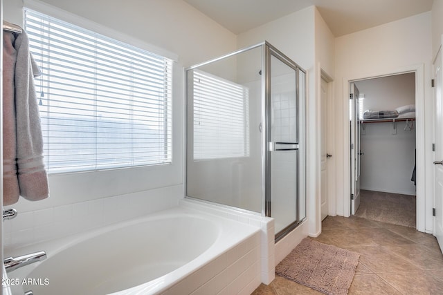 bathroom featuring tile patterned flooring, shower with separate bathtub, and a wealth of natural light