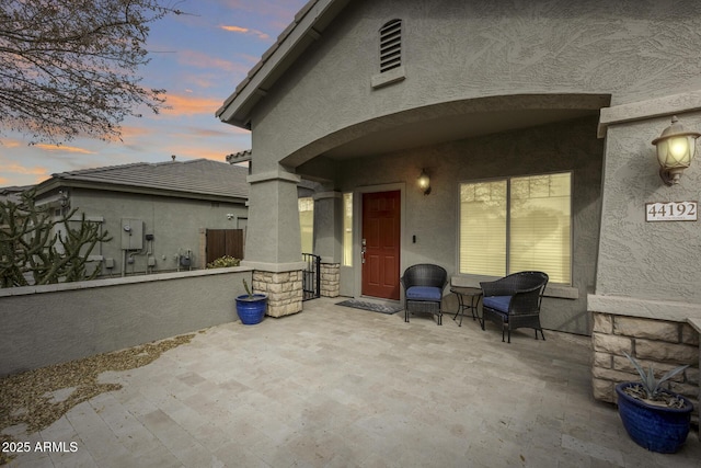 view of patio terrace at dusk