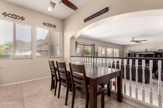 4834 E Robin Ln, Phoenix, AZ 85054 - dining room featuring a ceiling fan, arched walkways, and light tile patterned floors