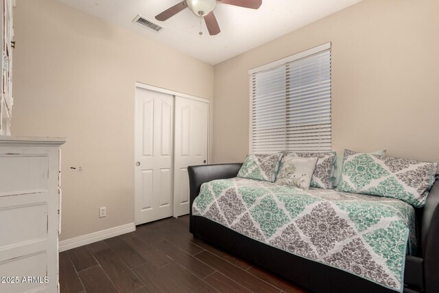 4834 E Robin Ln, Phoenix, AZ 85054 - bedroom with baseboards, a closet, dark wood-style floors, and a ceiling fan