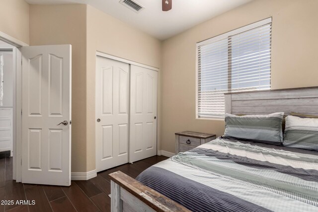 4834 E Robin Ln, Phoenix, AZ 85054 - bedroom featuring a closet, dark wood-type flooring, and baseboards