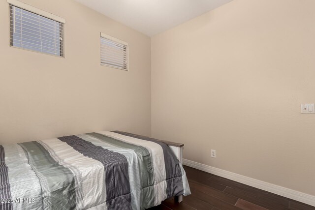 4834 E Robin Ln, Phoenix, AZ 85054 - bedroom with dark wood-style flooring and baseboards