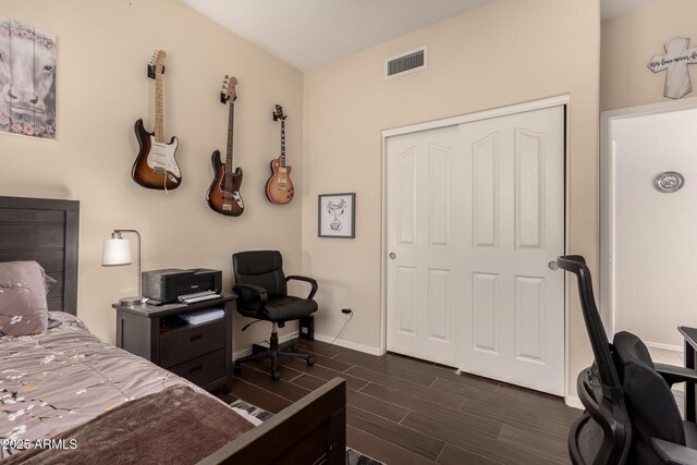 4834 E Robin Ln, Phoenix, AZ 85054 - bedroom with wood tiled floors, an office area, baseboards, and a closet