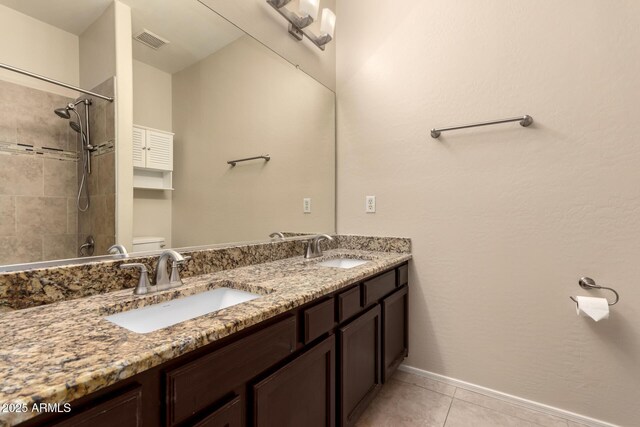 4834 E Robin Ln, Phoenix, AZ 85054 - full bathroom with toilet, tile patterned floors, double vanity, tiled shower, and baseboards