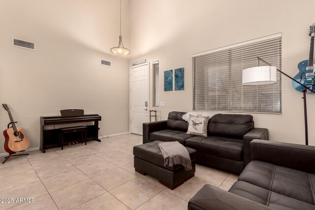 4834 E Robin Ln, Phoenix, AZ 85054 - living room featuring a high ceiling, light tile patterned floors, and baseboards