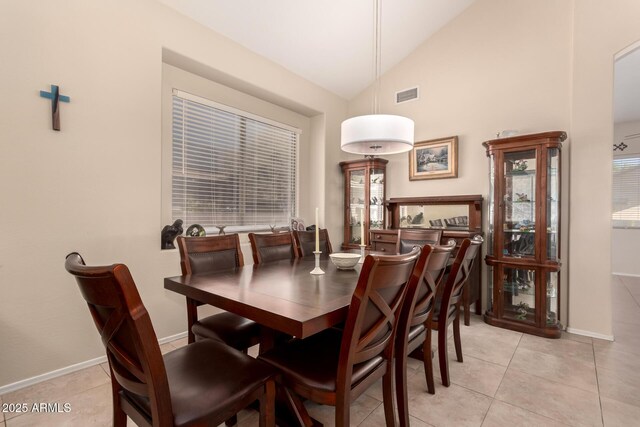 4834 E Robin Ln, Phoenix, AZ 85054 - dining area featuring light tile patterned floors, vaulted ceiling, baseboards, and arched walkways