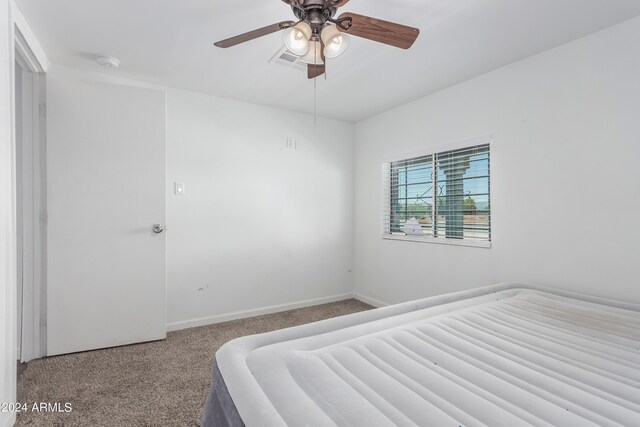 unfurnished bedroom featuring ceiling fan and carpet floors