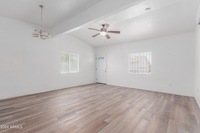 spare room with light hardwood / wood-style floors, vaulted ceiling with beams, and ceiling fan with notable chandelier