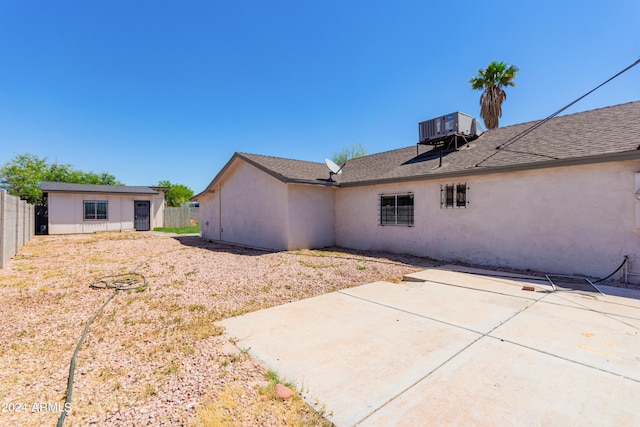 rear view of property with a patio area and central AC