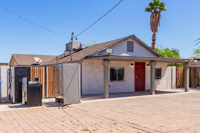 back of property with a patio