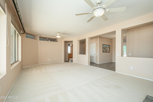 empty room featuring ceiling fan and carpet floors