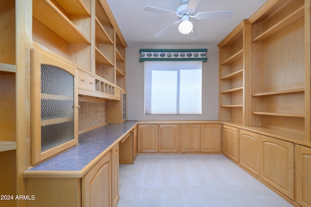 unfurnished office with ceiling fan and light colored carpet