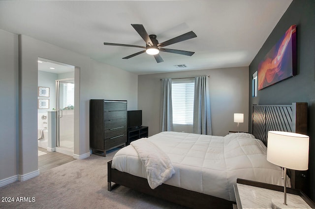 carpeted bedroom featuring ceiling fan and ensuite bathroom