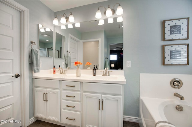 bathroom featuring wood-type flooring, vanity, and a washtub