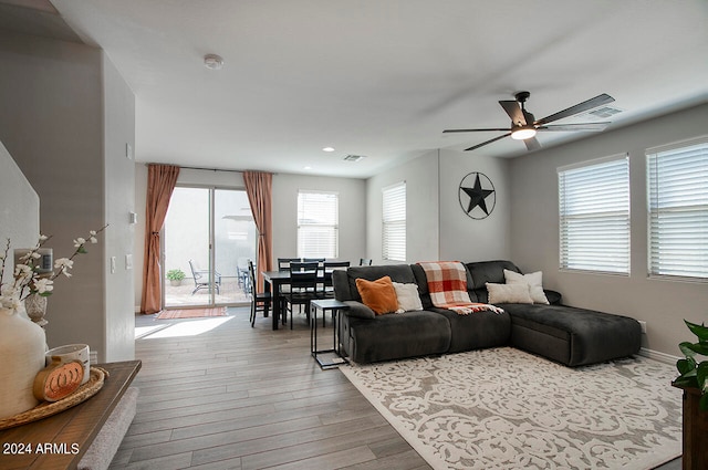 living room featuring light hardwood / wood-style floors, plenty of natural light, and ceiling fan