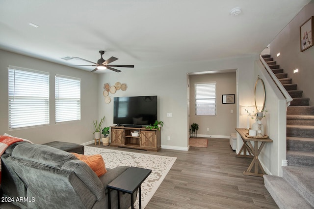 living room with a wealth of natural light, ceiling fan, and hardwood / wood-style flooring