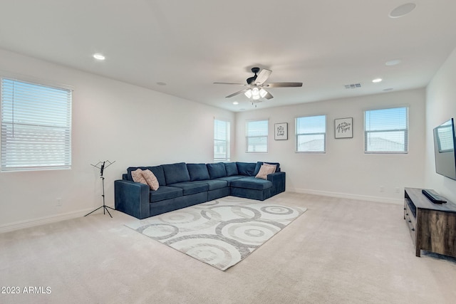 living room with light carpet and ceiling fan