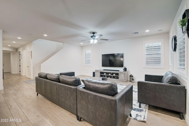 living room featuring ceiling fan and light wood-type flooring