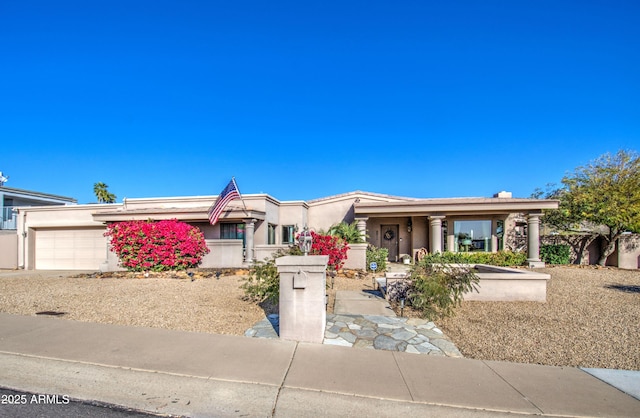 view of front of house with stucco siding and an attached garage