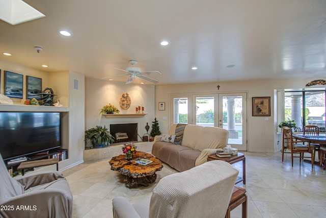 living room with baseboards, ceiling fan, recessed lighting, and light tile patterned floors