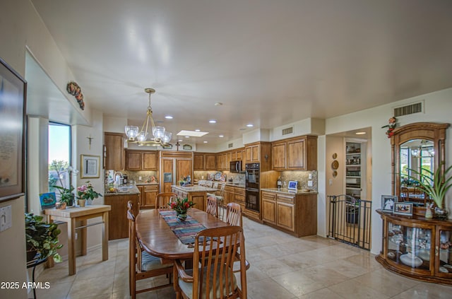 dining room with light tile patterned floors, recessed lighting, a chandelier, and visible vents