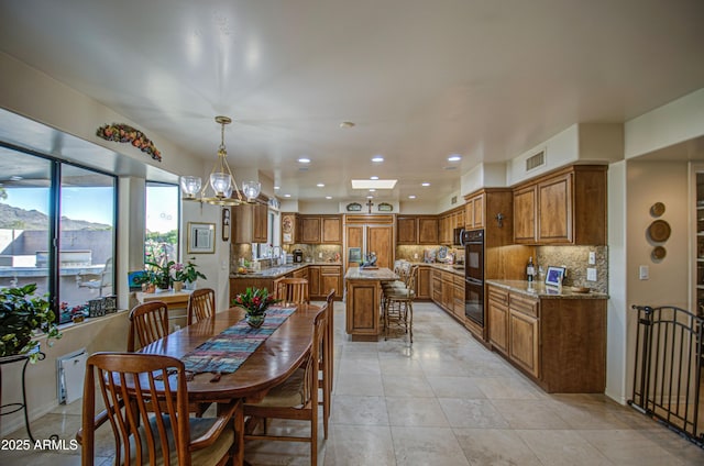 dining area with visible vents, an inviting chandelier, recessed lighting, and light tile patterned floors