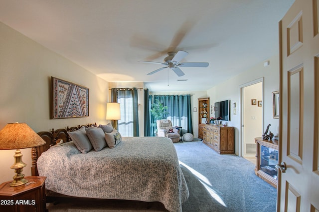carpeted bedroom featuring visible vents and a ceiling fan