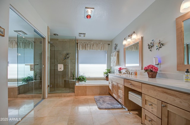 full bath with a stall shower, tile patterned floors, a garden tub, visible vents, and double vanity