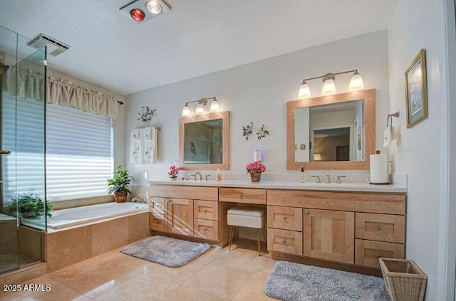 full bath with a bath, visible vents, tile patterned flooring, and a sink