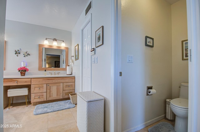 bathroom featuring tile patterned flooring, vanity, toilet, baseboards, and visible vents