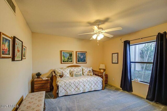 bedroom featuring baseboards, a ceiling fan, visible vents, and carpet